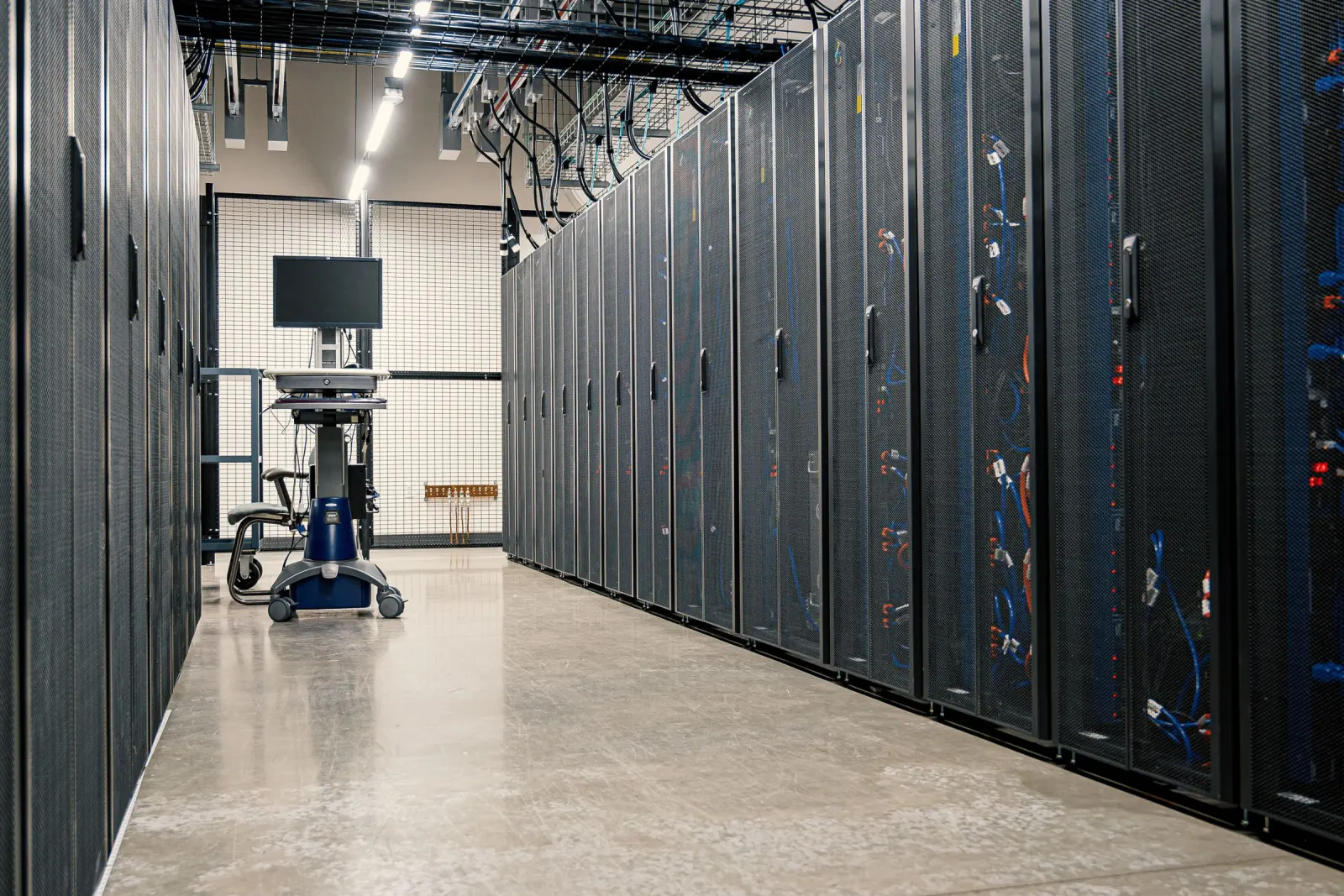 A data-centre corridor lined with server racks.