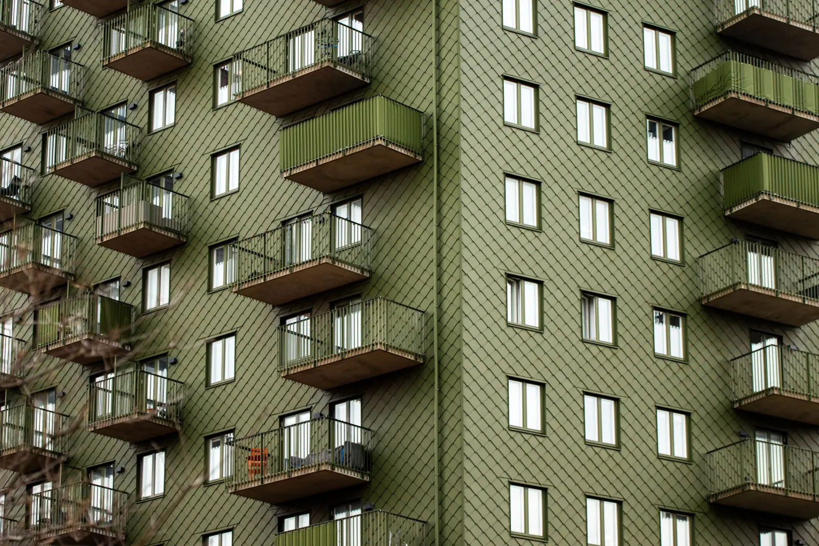 The facade of a Swedish apartment building with timber balconies.
